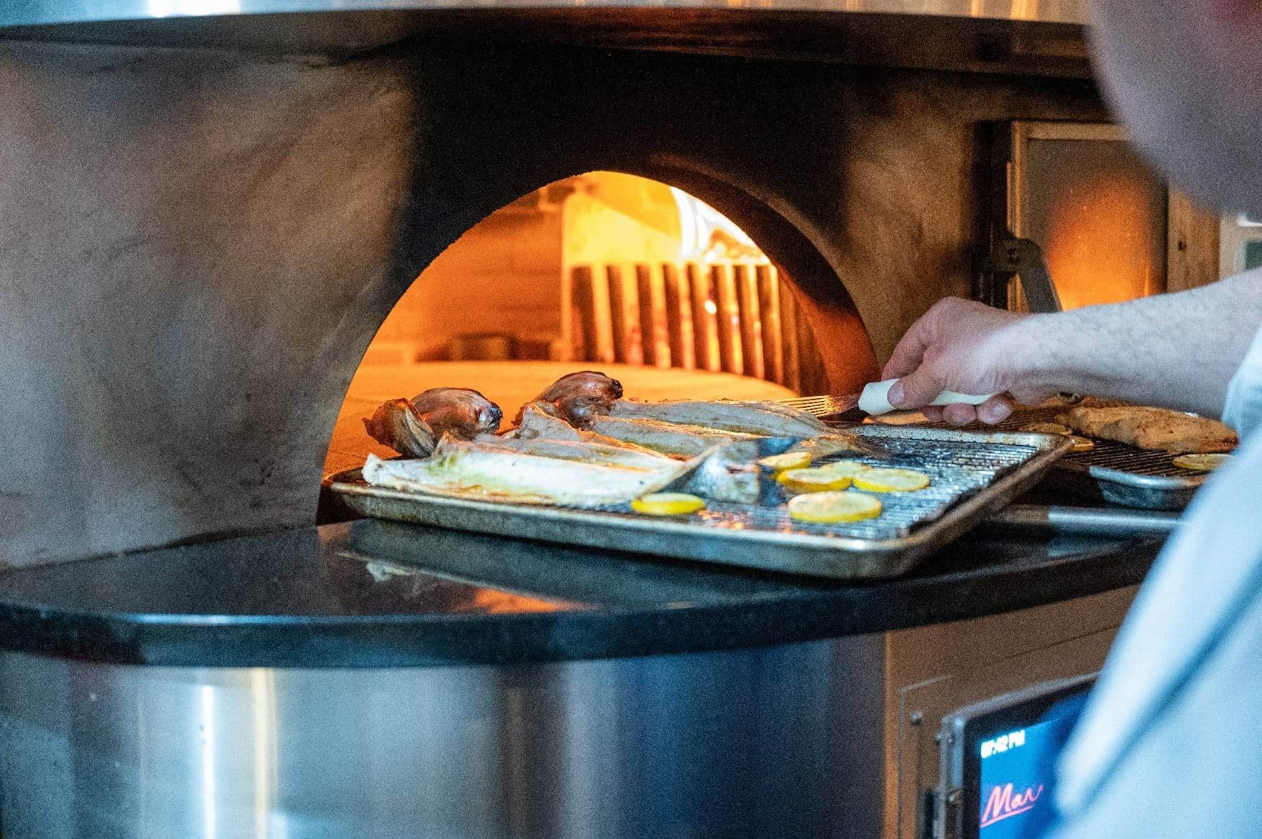 Fish roasting in Stellina's wood-fired oven