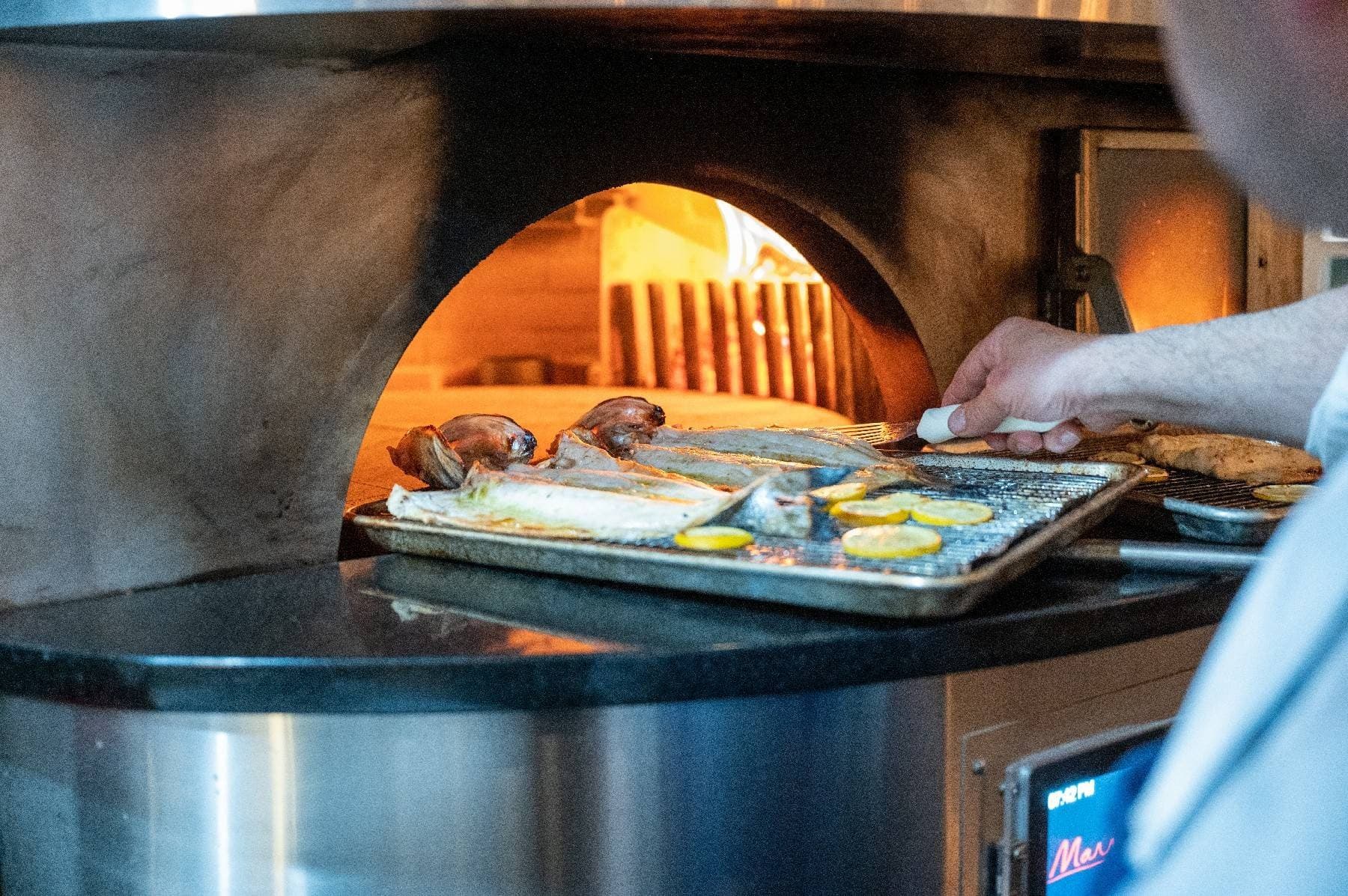 Fish roasting in Stellina's wood-fired oven